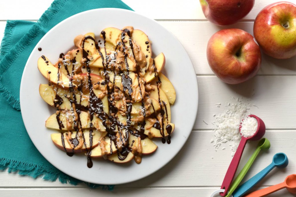 You won't believe these quick & easy Dark Chocolate Peanut Butter Apples are a healthy snack or dessert! Apples, dark chocolate, peanut butter, coconut, and almonds are the perfect flavor combo!
