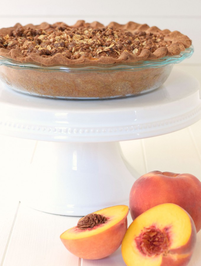 Peach pie and peach crumble come together in a healthy dessert makeover! This Peach Crumble Pie comes with all the flavor, a flakey crust, and a sweet streusel topping - but with whole grains and no refined sugar! | Feel Great in 8 - Healthy Real Food Recipes