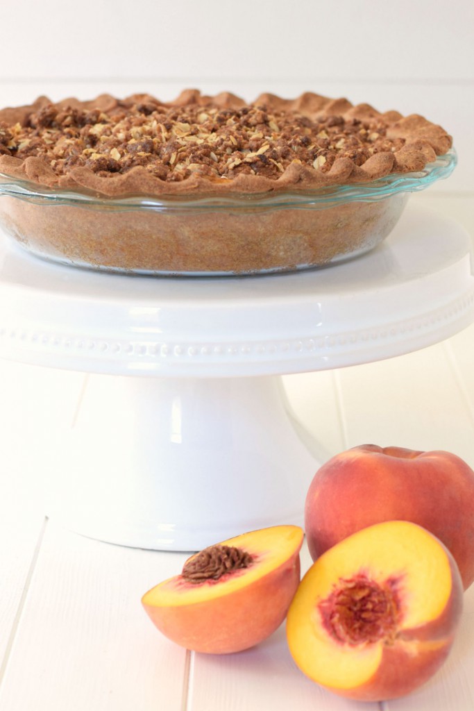 Peach pie and peach cobbler come together in a healthy dessert makeover! This Peach Crumble Pie comes with all the flavor, a flakey crust, and a sweet streusel topping - but with whole grains and no refined sugar!