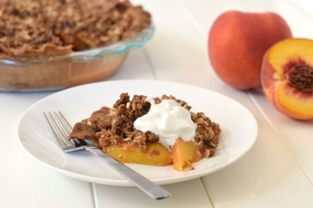 Peach pie and peach cobbler come together in a healthy dessert makeover! This Peach Crumble Pie comes with all the flavor, a flakey crust, and a sweet streusel topping - but with whole grains and no refined sugar!